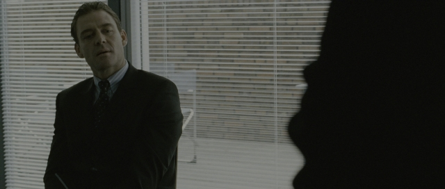 Frame from The Bourne Supremacy — standing, suit, tie
