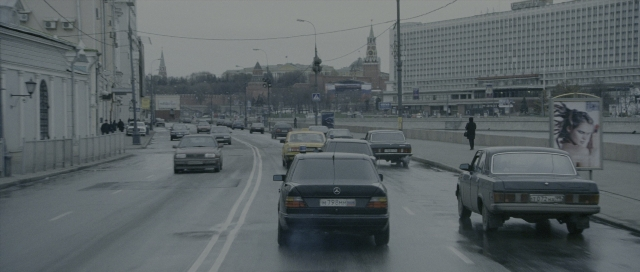 Wide shot frame from The Bourne Supremacy — walking, street, car