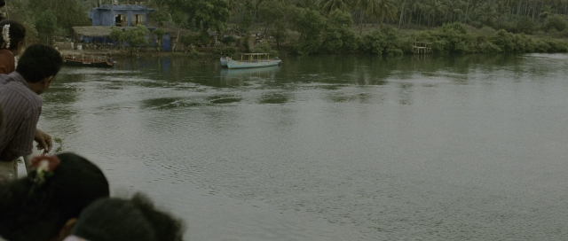 Wide shot frame from The Bourne Supremacy — standing, water, boat