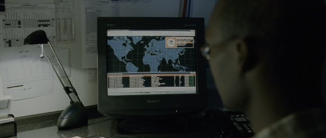 Wide shot frame from The Bourne Supremacy — sitting, office, lamp
