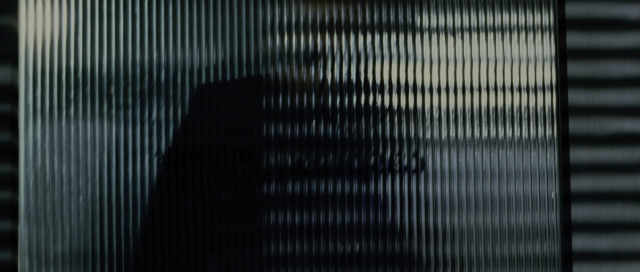 Wide shot frame from The Bourne Supremacy — face, person, window