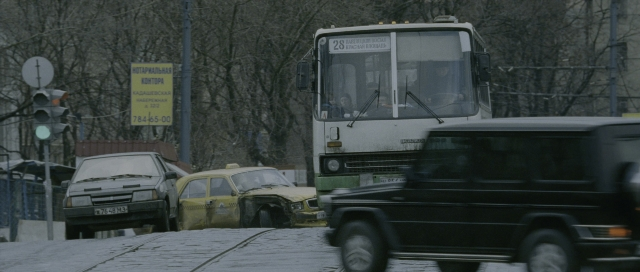 Wide shot frame from The Bourne Supremacy — street, car, bus