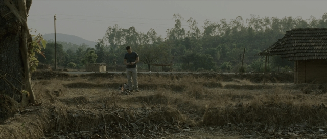 Wide shot frame from The Bourne Supremacy — standing, hand, shirt