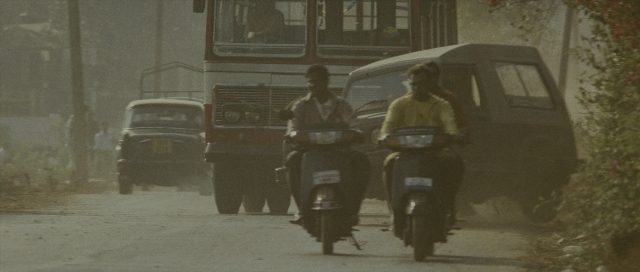 Wide shot frame from The Bourne Supremacy — street, bus, motorcycle
