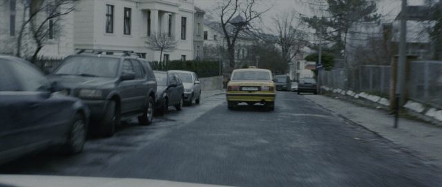 Wide shot frame from The Bourne Supremacy — street, car, lamp
