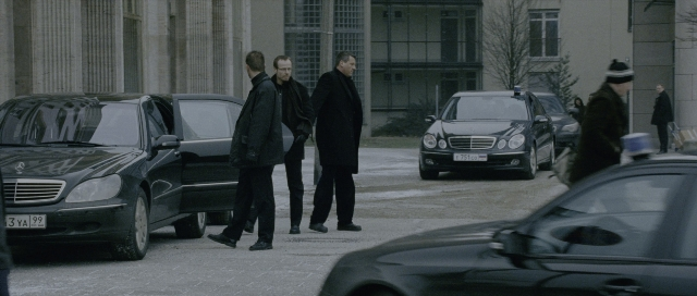 Wide shot frame from The Bourne Supremacy — walking, street, car