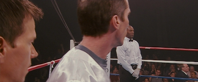 Wide shot frame from The Fighter — standing, dialogue, tie