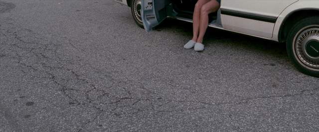 Frame from The Fighter — sitting, door, street