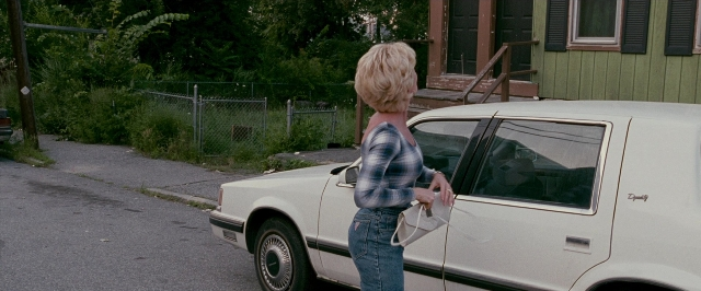 Wide shot frame from The Fighter — standing, street, car
