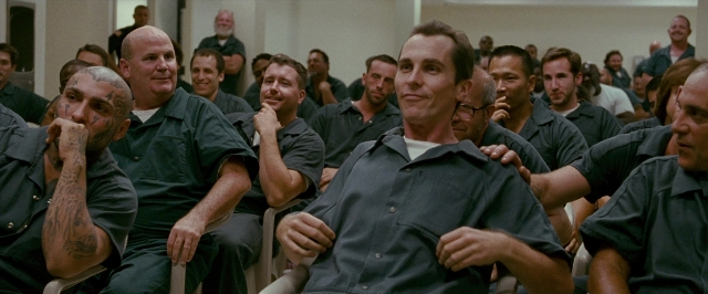 Wide shot frame from The Fighter — sitting, room, person