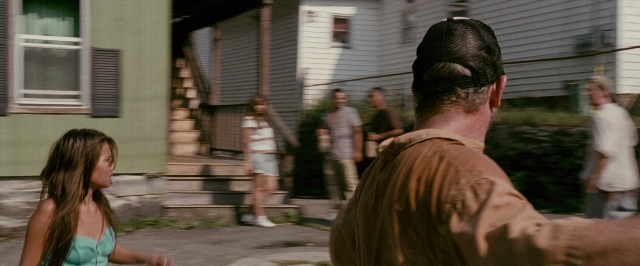 Wide shot frame from The Fighter — standing, walking, street