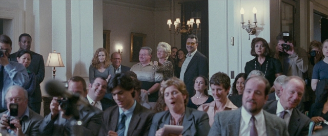 Wide shot frame from The Fighter — standing, room, dialogue