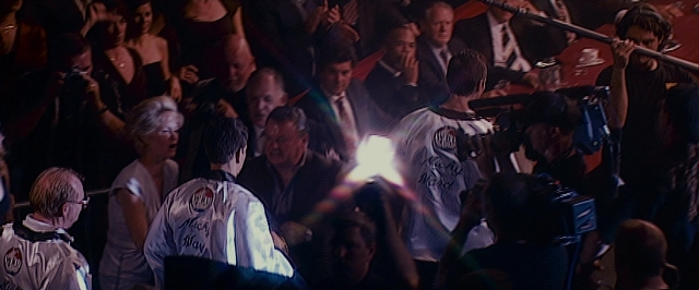 Wide shot frame from The Fighter — room, dialogue, shirt