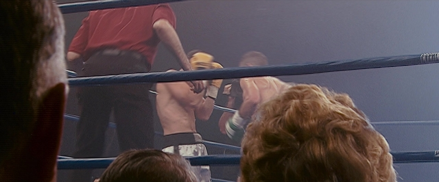 Wide shot frame from The Fighter — standing, shirt, face