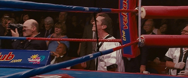 Wide shot frame from The Fighter — standing, shirt, face