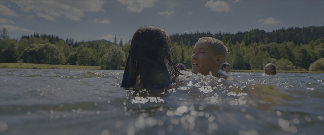 Wide shot frame from The Hunger Games: The Ballad of Songbirds & Snakes — standing, water, hair