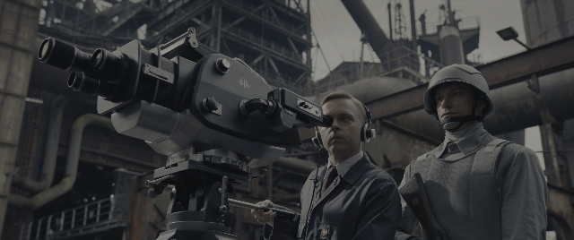 Wide shot frame from The Hunger Games: The Ballad of Songbirds & Snakes — standing, hat, suit