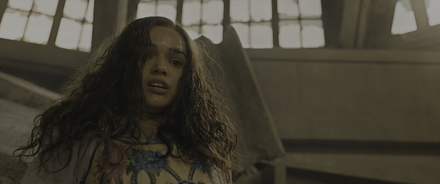 Wide shot frame from The Hunger Games: The Ballad of Songbirds & Snakes — standing, dress, face