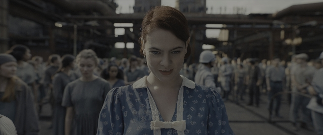 Medium shot frame from The Hunger Games: The Ballad of Songbirds & Snakes — standing, tie, dress