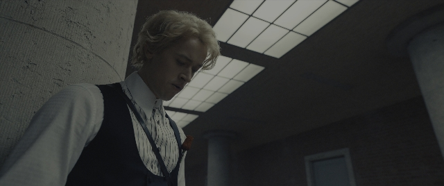 Frame from The Hunger Games: The Ballad of Songbirds & Snakes — standing, room, shirt