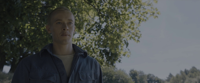 Wide shot frame from The Hunger Games: The Ballad of Songbirds & Snakes — standing, shirt, jacket