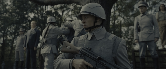 Wide shot frame from The Hunger Games: The Ballad of Songbirds & Snakes — standing, hat, uniform