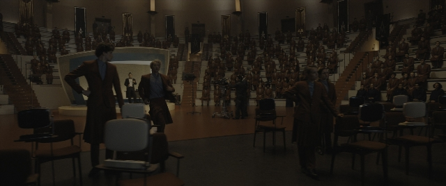 Wide shot frame from The Hunger Games: The Ballad of Songbirds & Snakes — sitting, standing, dialogue