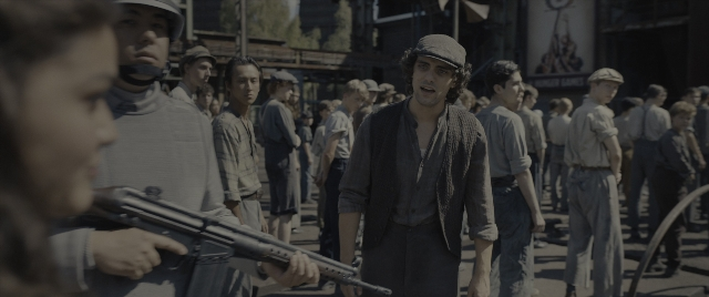 Wide shot frame from The Hunger Games: The Ballad of Songbirds & Snakes — standing, dialogue, street