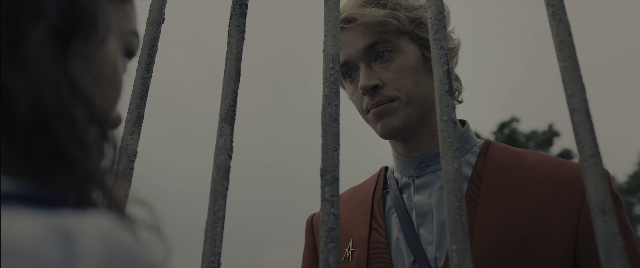 Wide shot frame from The Hunger Games: The Ballad of Songbirds & Snakes — standing, shirt, face