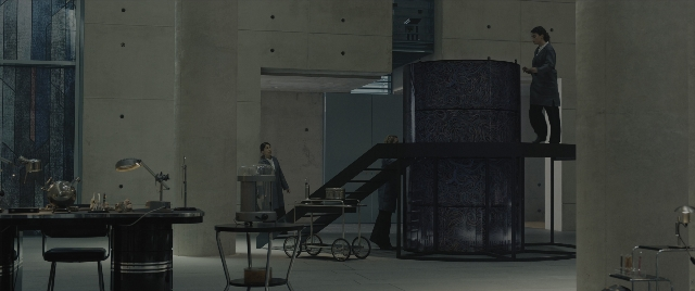 Wide shot frame from The Hunger Games: The Ballad of Songbirds & Snakes — standing, room, table