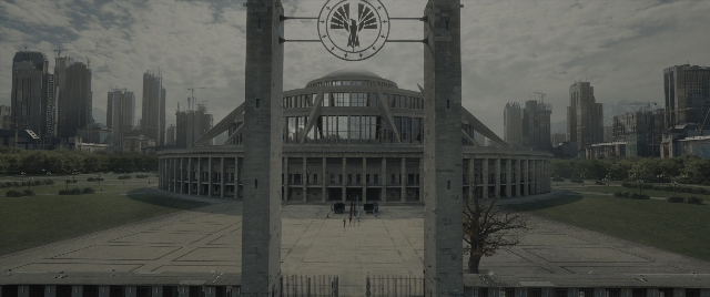 Wide shot frame from The Hunger Games: The Ballad of Songbirds & Snakes — clock, skyscraper
