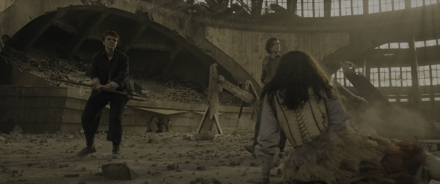 Wide shot frame from The Hunger Games: The Ballad of Songbirds & Snakes — standing, face, hair