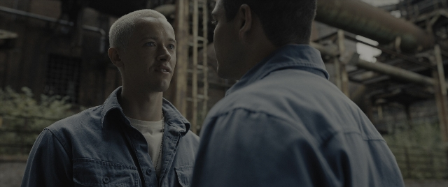 Wide shot frame from The Hunger Games: The Ballad of Songbirds & Snakes — standing, shirt, face