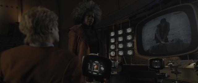Wide shot frame from The Hunger Games: The Ballad of Songbirds & Snakes — standing, room, dialogue