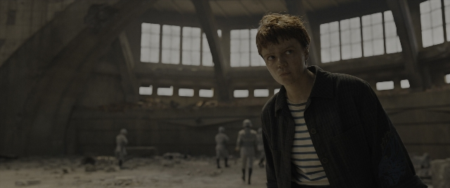 Wide shot frame from The Hunger Games: The Ballad of Songbirds & Snakes — standing, walking, shirt