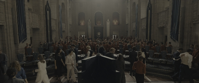 Wide shot frame from The Hunger Games: The Ballad of Songbirds & Snakes — room, person