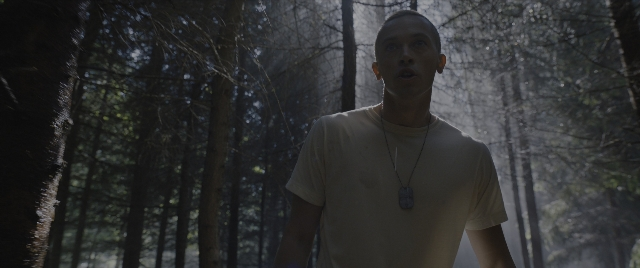 Wide shot frame from The Hunger Games: The Ballad of Songbirds & Snakes — standing, shirt, face