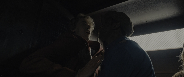 Wide shot frame from The Hunger Games: The Ballad of Songbirds & Snakes — standing, room, face