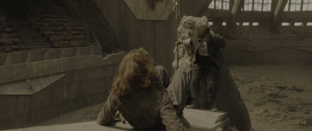 Wide shot frame from The Hunger Games: The Ballad of Songbirds & Snakes — sitting, standing, face