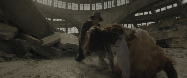 Wide shot frame from The Hunger Games: The Ballad of Songbirds & Snakes — walking, hat, coat