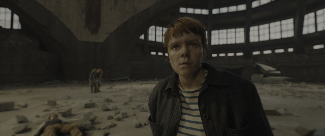 Wide shot frame from The Hunger Games: The Ballad of Songbirds & Snakes — standing, walking, shirt