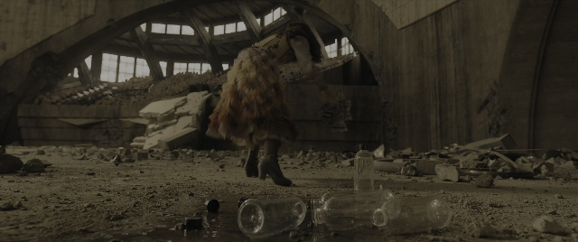 Wide shot frame from The Hunger Games: The Ballad of Songbirds & Snakes — walking, dress, glass