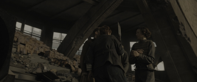 Wide shot frame from The Hunger Games: The Ballad of Songbirds & Snakes — standing, person, human face