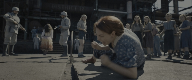 Wide shot frame from The Hunger Games: The Ballad of Songbirds & Snakes — standing, dress, person