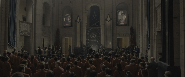 Wide shot frame from The Hunger Games: The Ballad of Songbirds & Snakes — standing, room, person