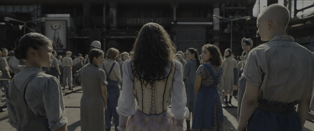 Wide shot frame from The Hunger Games: The Ballad of Songbirds & Snakes — standing, shirt, hair