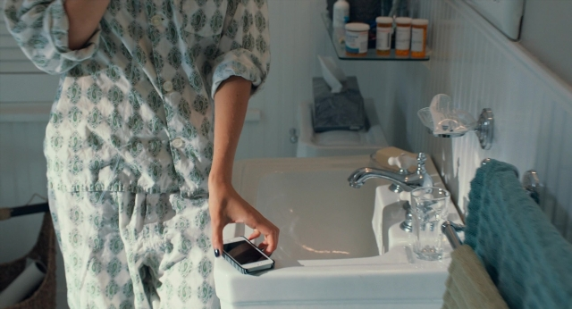 Wide shot frame from The Fault in Our Stars — standing, phone, hand