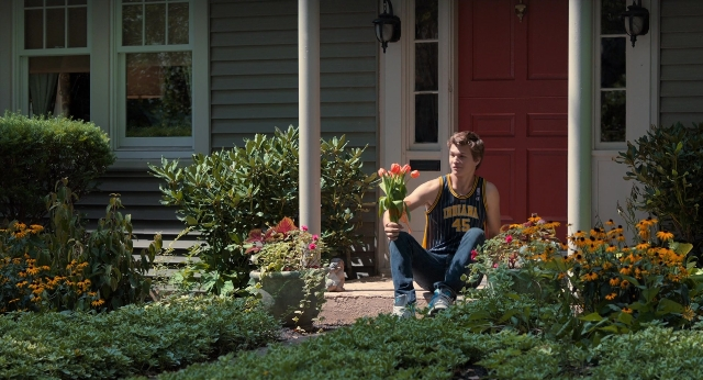 Wide shot frame from The Fault in Our Stars — sitting, door, hand