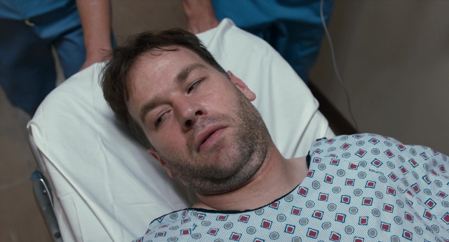 Wide shot frame from The Fault in Our Stars — bed, hand, person