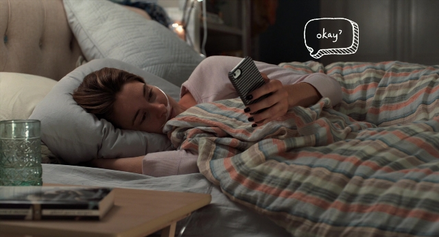 Frame from The Fault in Our Stars — table, bed, phone